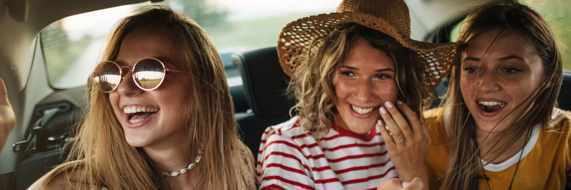 group of young woman inside a car