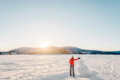 A lady walking in the snow.