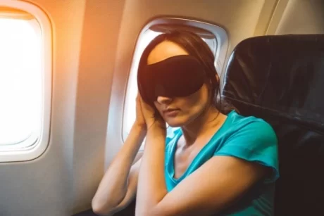 woman on the plane with sleeping blindfold