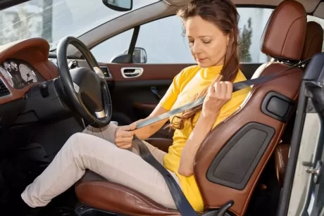 A woman putting on her safety belt